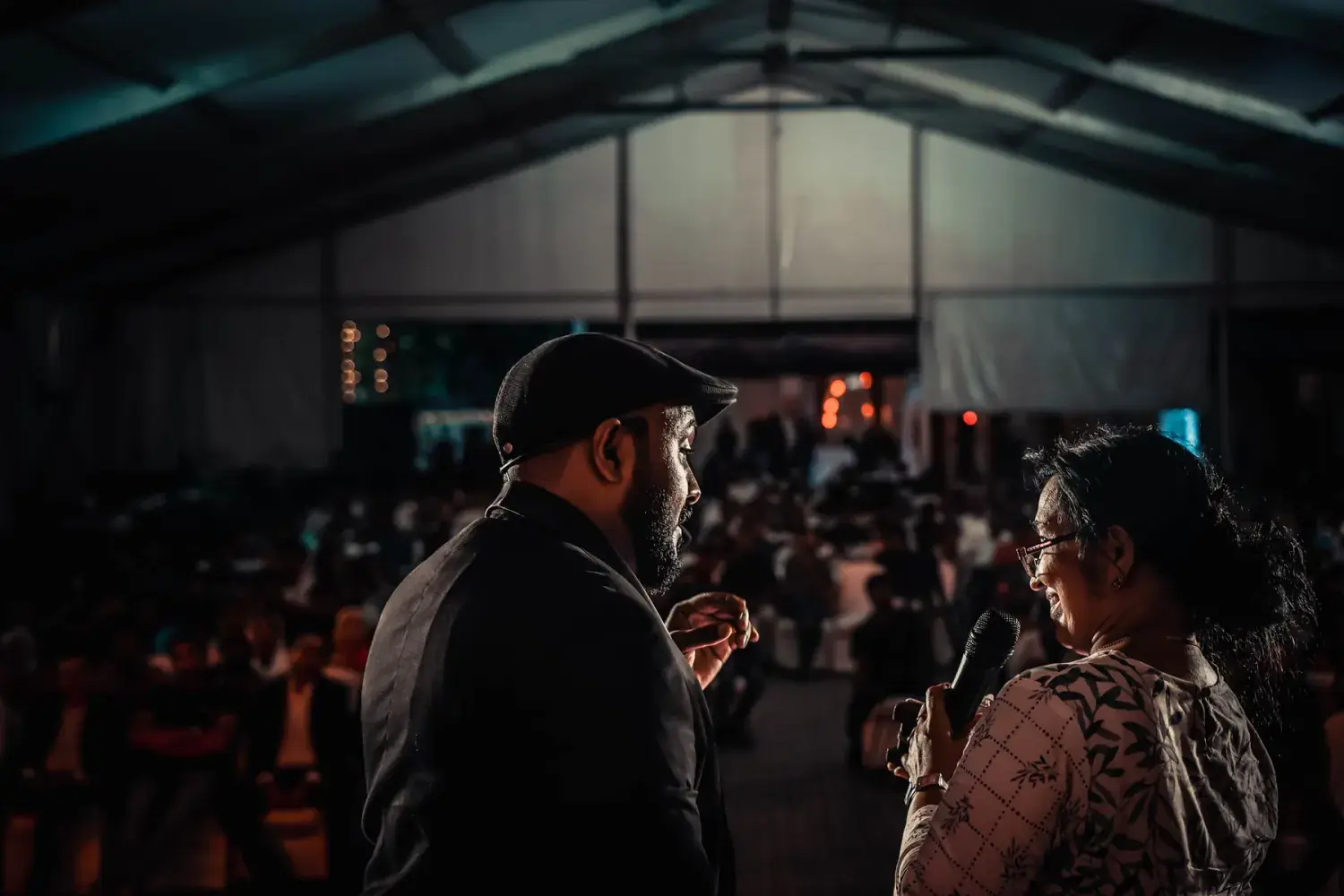 Guests gathered under an event marquee during an evening activation