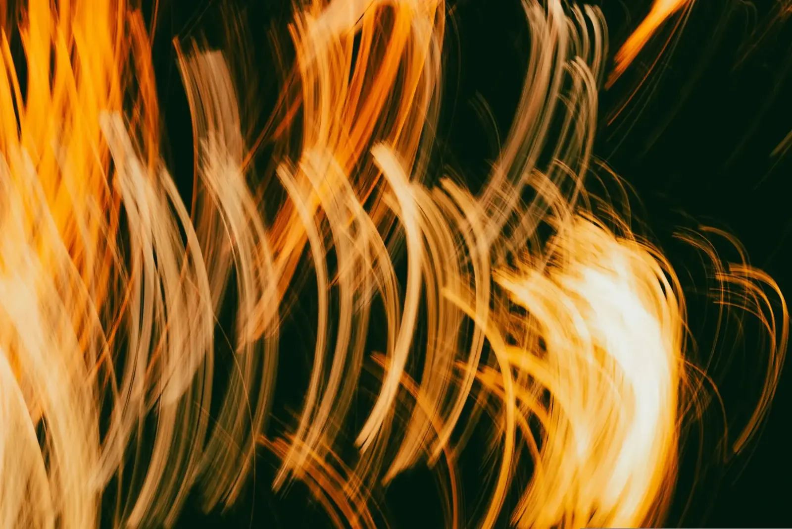 Abstract long-exposure light trails in warm gold tones
