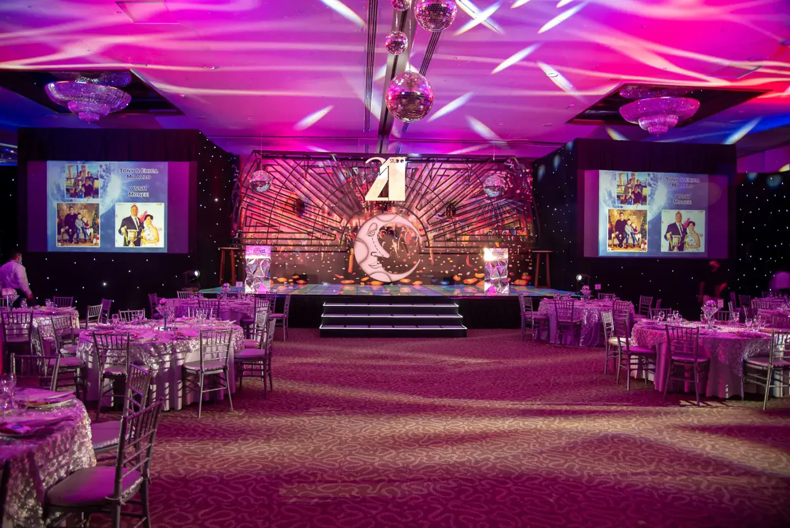 Awards night stage and banquet floor lit in magenta and gold