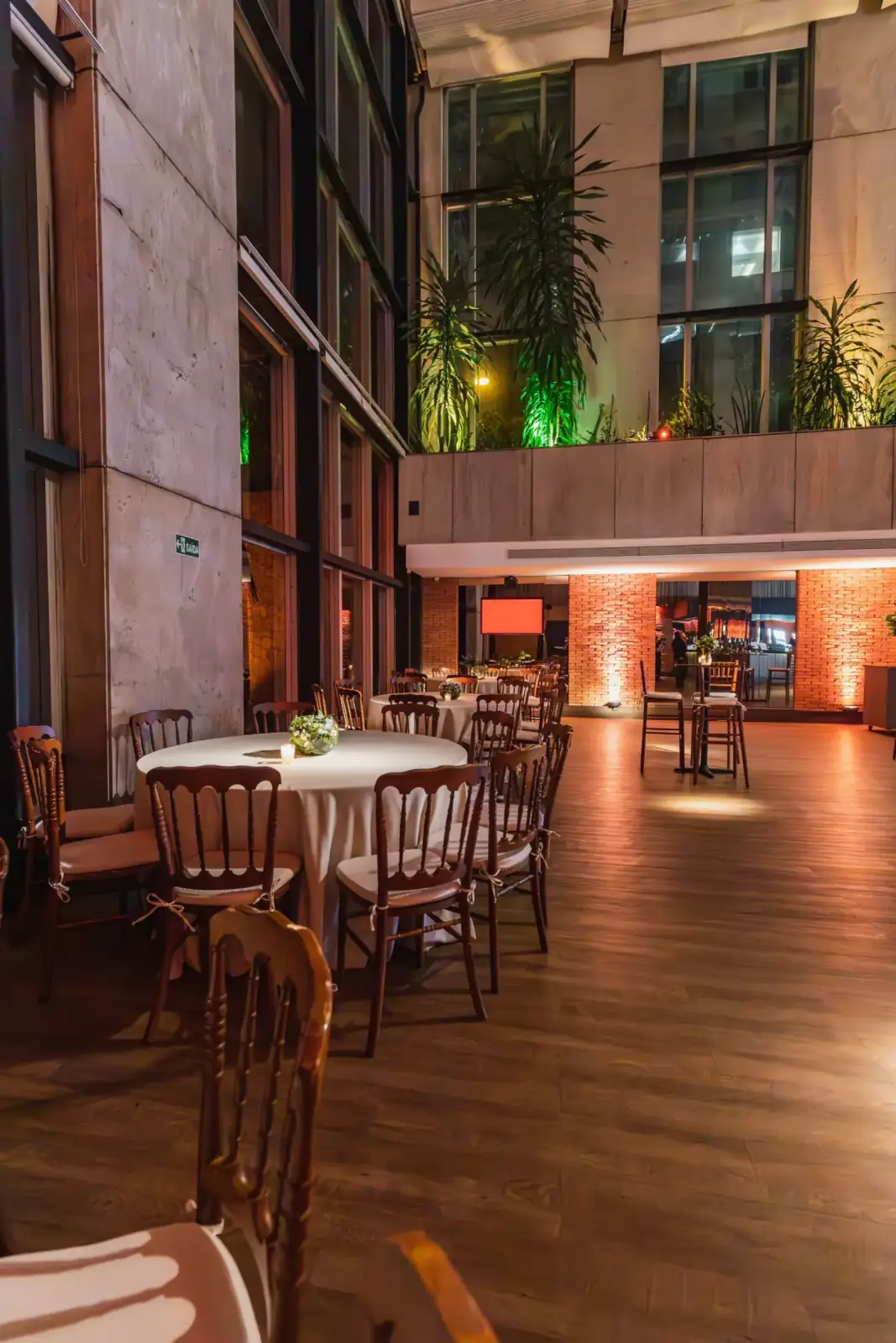 Event space set with round tables and chairs ahead of a corporate programme